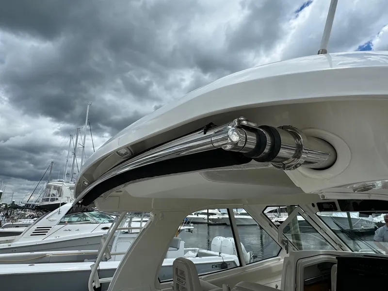 Slide: The Image of 2020 Boston Whaler 380 Realm boat docked under cloudy skies. - 15