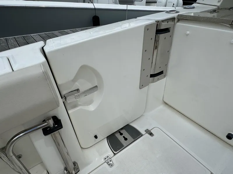 Slide: The Image of 2020 Boston Whaler 380 Realm boat deck with open hatch and stainless steel hardware. - 19