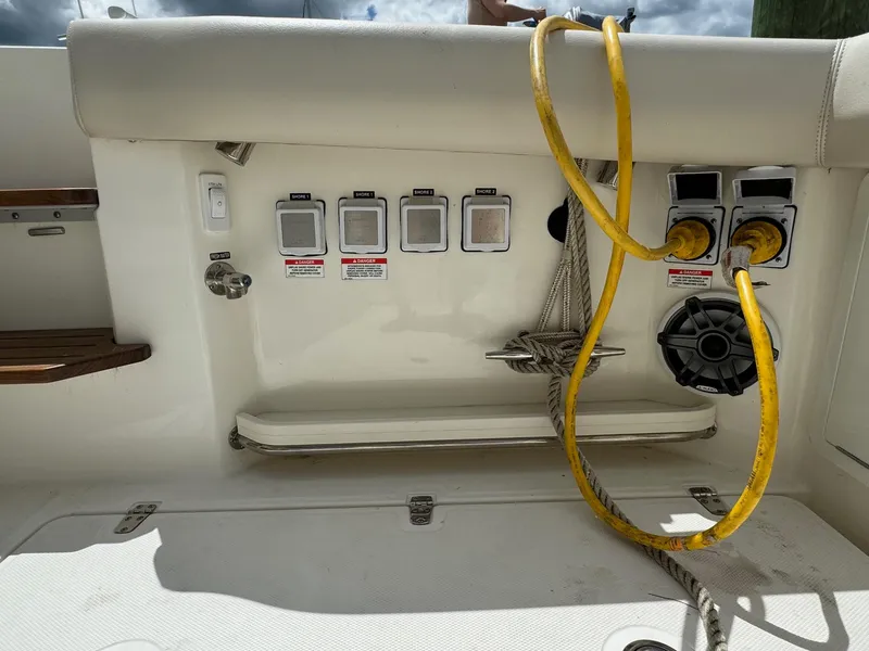 Slide: The Image of Control panel and power outlets on a 2020 Boston Whaler 380 Realm boat. - 20