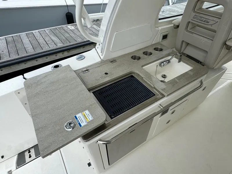 Slide: The Image of 2020 Boston Whaler 380 Realm outdoor kitchen with sink and grill. - 22