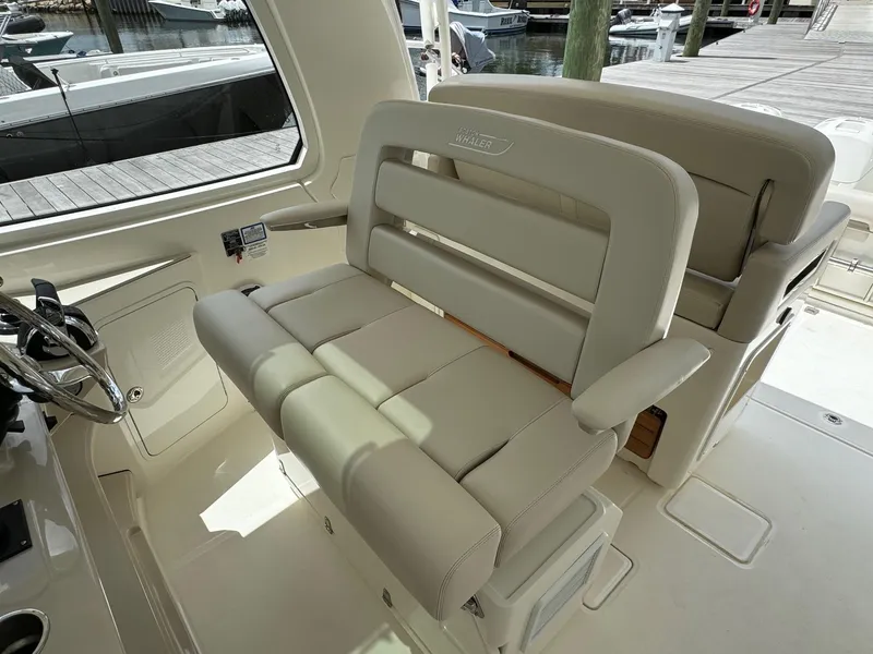 Slide: The Image of 2020 Boston Whaler 380 Realm helm seating with beige upholstery. - 27