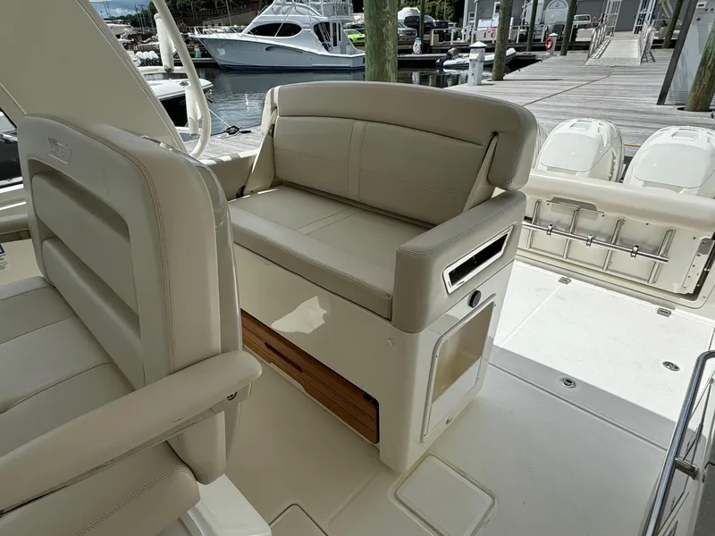 Slide: The Image of 2020 Boston Whaler 380 Realm boat interior seating and dock view. - 28