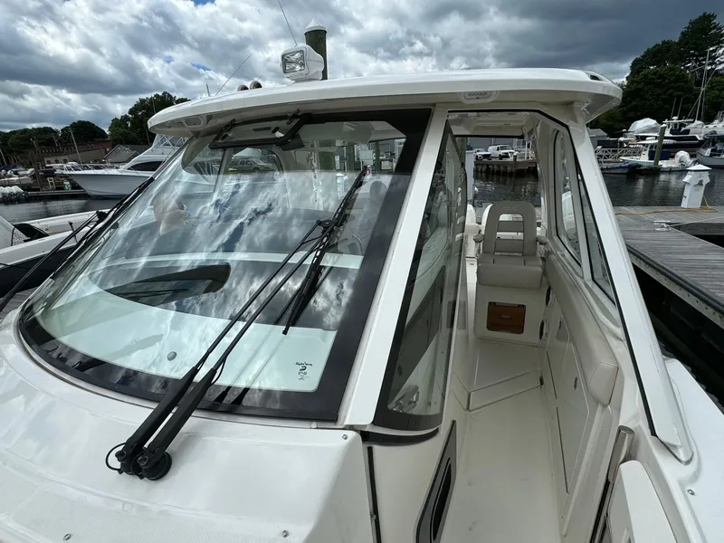 Slide: The Image of 2020 Boston Whaler 380 Realm boat docked at marina, front view. - 34