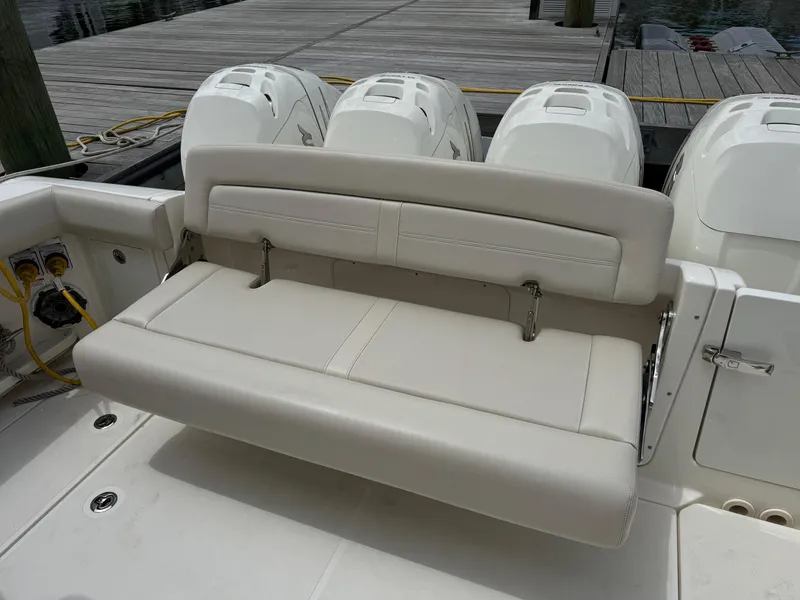 Slide: The Image of Boston Whaler 380 Realm 2020 boat with foldable rear bench seat and triple outboard engines. - 35