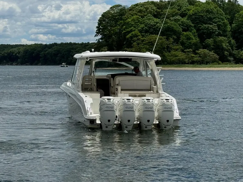Slide: The Image of 2020 Boston Whaler 380 Realm boat with quad outboard engines on a lake. - 5