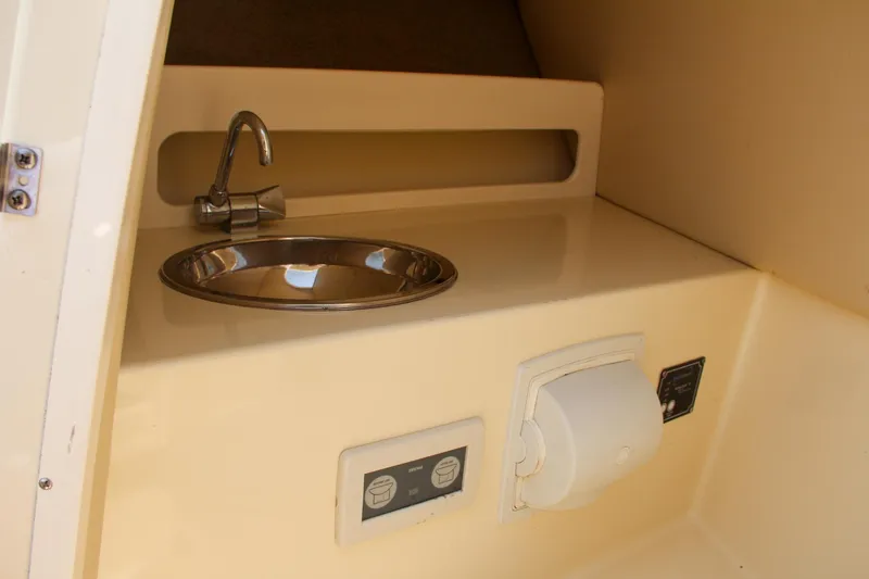 Slide: The Image of 2013 Chris-Craft Launch 28 boat interior with beige leather seats and wooden dashboard. - 27