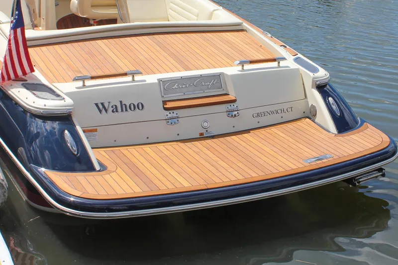 Slide: The Image of 2013 Chris-Craft Launch 28 boat cruising on a calm lake with American flag. - 3