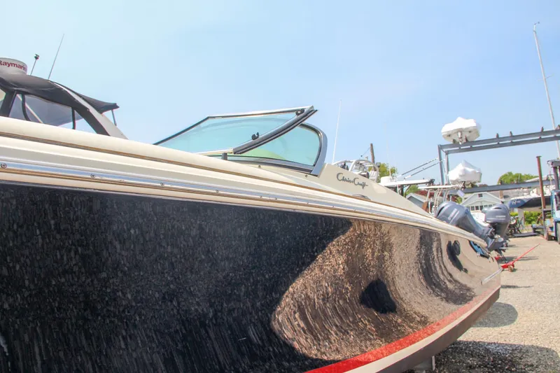 Slide: The Image of 2013 Chris-Craft Launch 28 boat with beige leather seating and wooden deck. - 31