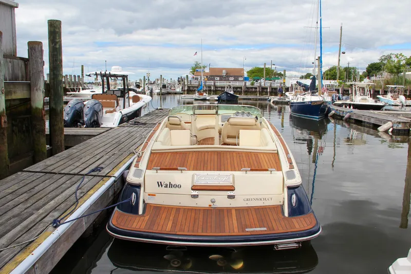 Slide: The Image of 2013 Chris-Craft Launch 28 boat with teak deck, displayed indoors. - 4