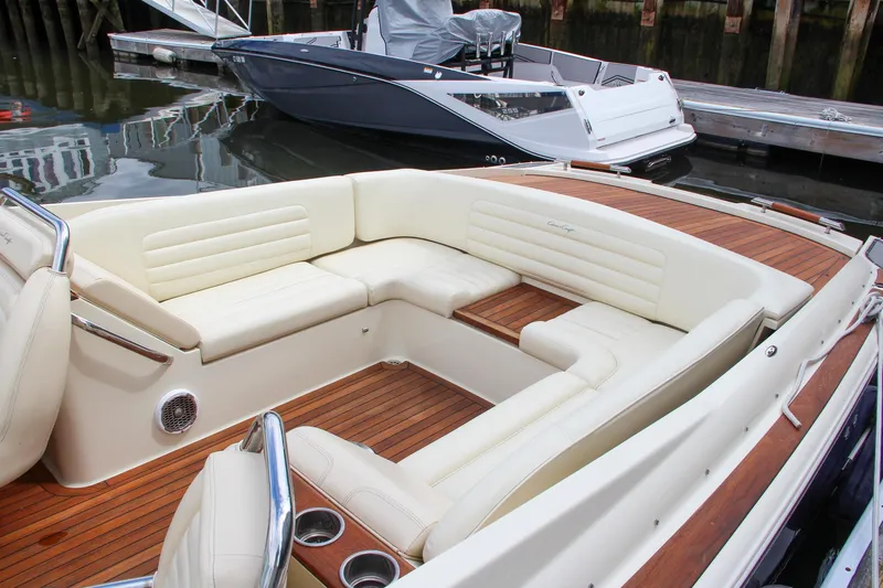 Slide: The Image of 2013 Chris-Craft Launch 28 boat docked, featuring a sleek design and luxurious seating. - 45