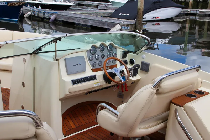 Slide: The Image of 2013 Chris-Craft Launch 28 boat with spacious seating at a marina. - 47
