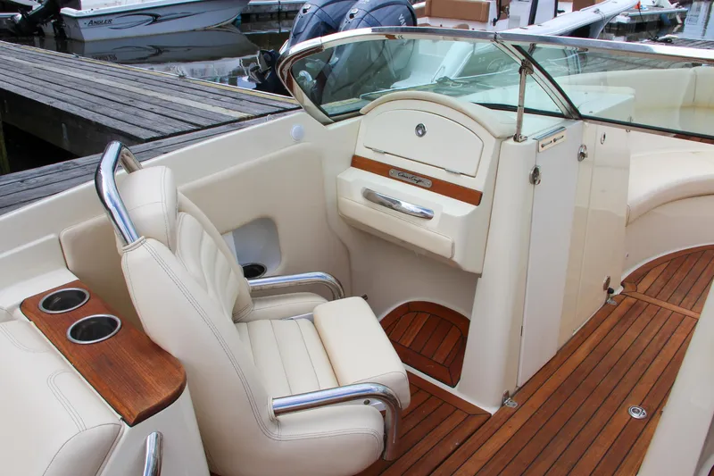 Slide: The Image of 2013 Chris-Craft Launch 28 boat with teak wood deck and cream seating. - 49