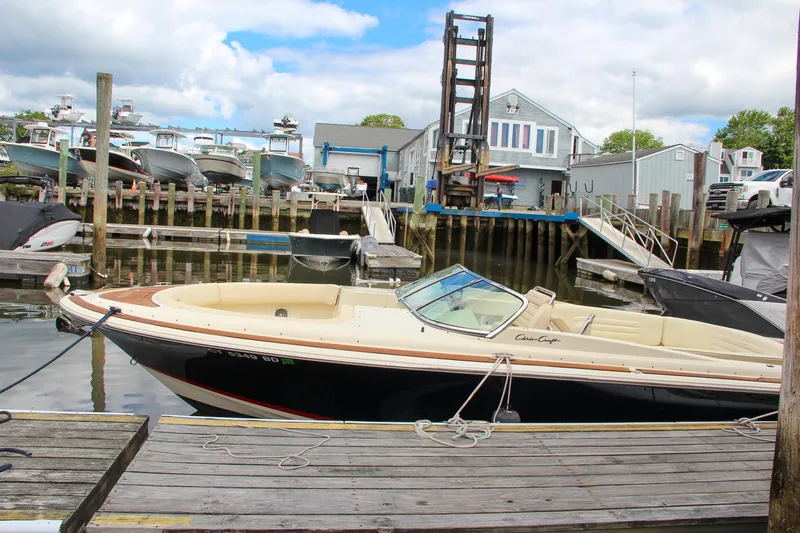 Slide: The Image of 2013 Chris-Craft Launch 28 boat interior with luxurious seating and wooden deck. - 5