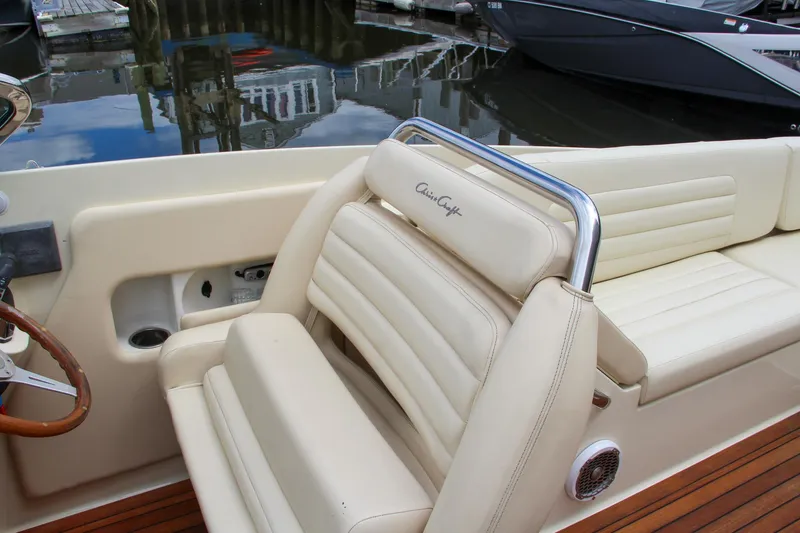 Slide: The Image of 2013 Chris-Craft Launch 28 boat dashboard with steering wheel and navigation system. - 50