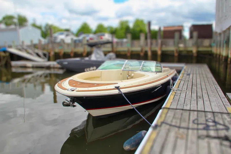 Slide: The Image of 2013 Chris-Craft Launch 28 boat interior with cream leather seating and wooden accents. - 55