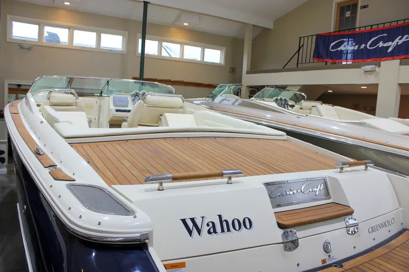 Slide: The Image of 2013 Chris-Craft Launch 28 boat with teak deck, displayed indoors. - 64