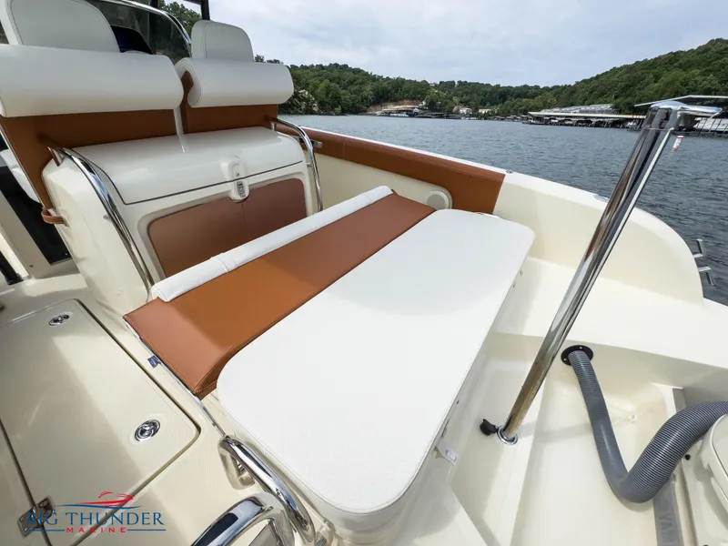 Slide: The Image of 2024 Capoforte FX240 boat interior with cushioned seating and scenic lake view. - 12