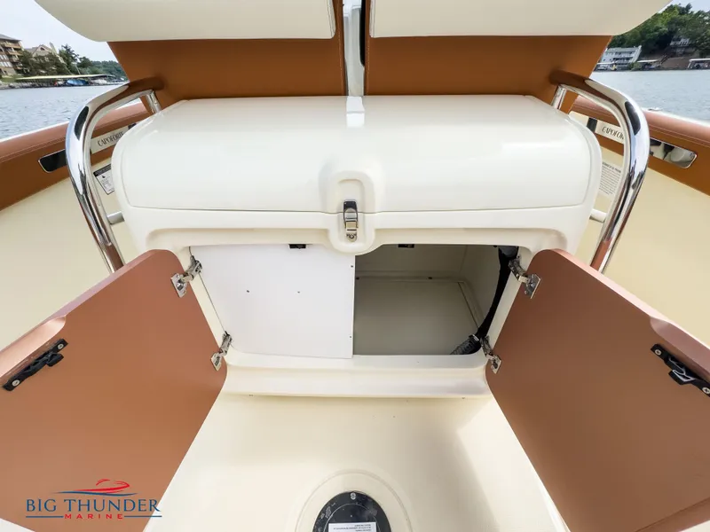 Slide: The Image of 2024 Capoforte FX240 boat storage compartment with open doors, Big Thunder Marine logo. - 14