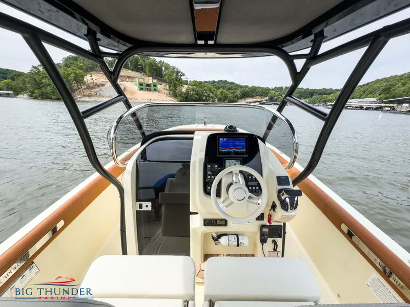 Slide: The Image of 2024 Capoforte FX240 boat interior with steering console on a lake. - 16