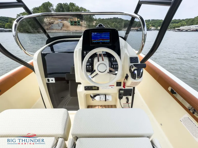 Slide: The Image of 2024 Capoforte FX240 boat dashboard with steering wheel and navigation system on a lake. - 17