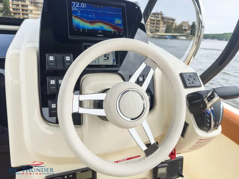 Slide: The Image of 2024 Capoforte FX240 boat dashboard with steering wheel and navigation display. - 19