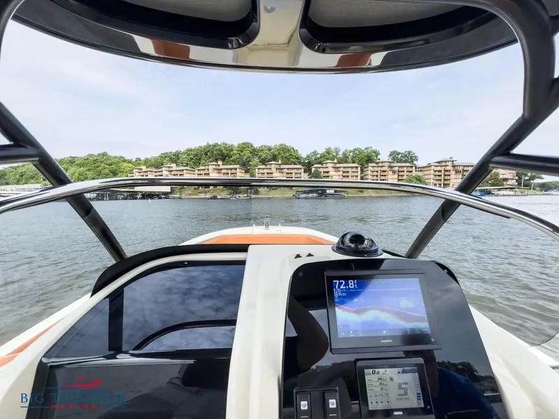 Slide: The Image of 2024 Capoforte FX240 boat dashboard with navigation screen on a lake. - 21