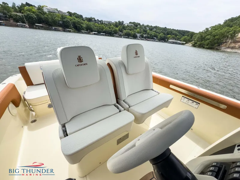 Slide: The Image of 2024 Capoforte FX240 boat interior with white seats on a lake. - 23