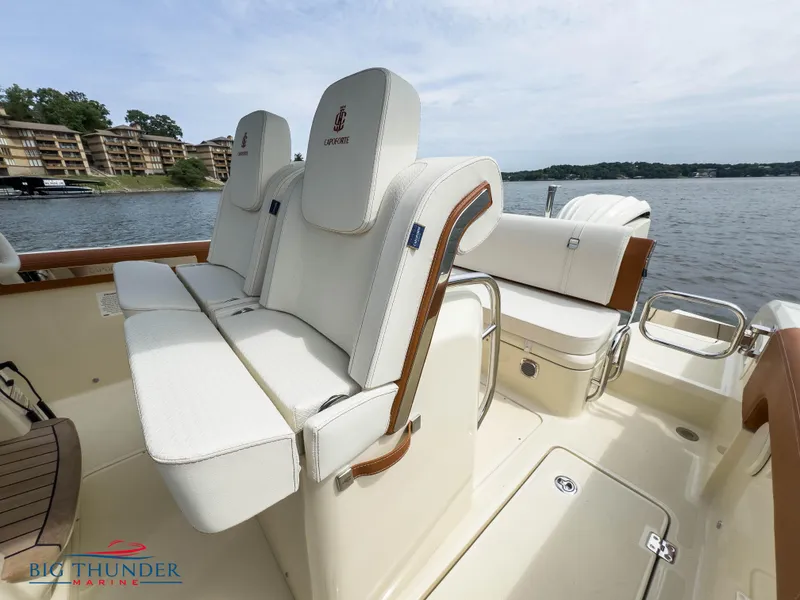 Slide: The Image of 2024 Capoforte FX240 boat interior with white seating and lake view. - 25