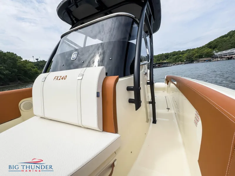 Slide: The Image of 2024 Capoforte FX240 boat interior with white and brown seating, Big Thunder Marine logo. - 28
