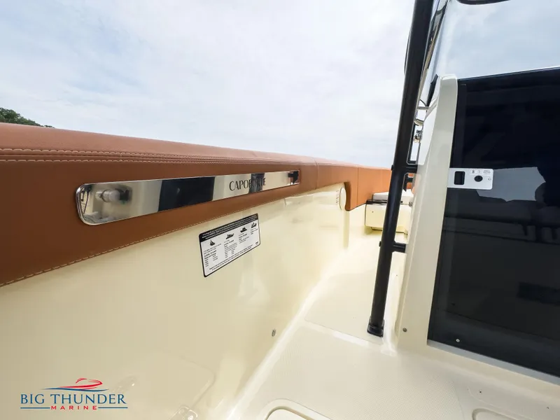 Slide: The Image of 2024 Capoforte FX240 boat interior with brown leather trim and Big Thunder Marine logo. - 33