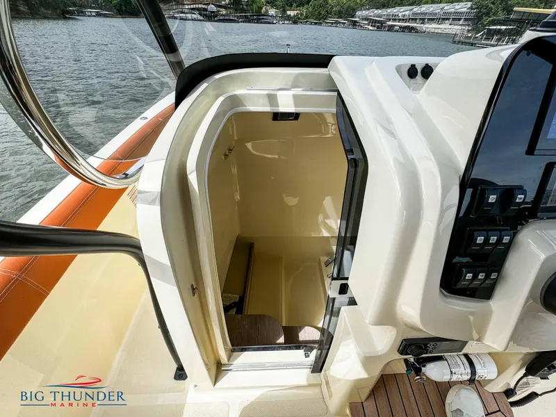 Slide: The Image of 2024 Capoforte FX240 boat interior cabin with open door, Big Thunder Marine logo. - 35