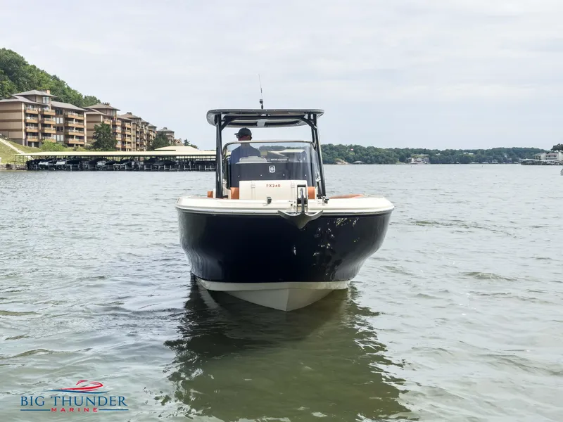 Slide: The Image of 2024 Capoforte FX240 boat on water near marina, front view. - 5
