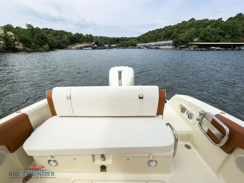 Slide: The Image of 2024 Capoforte FX240 boat on a lake with scenic forested shoreline. - 7