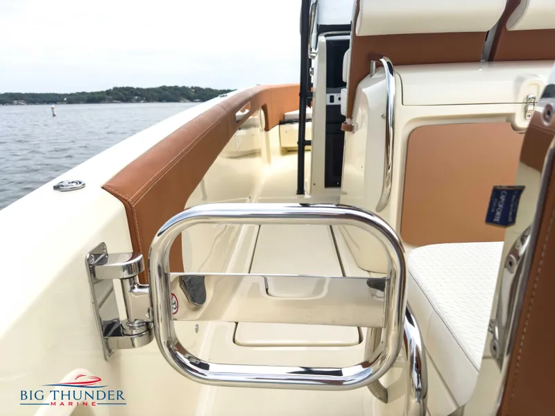 Slide: The Image of Capoforte FX240 2024 boat interior with chrome railing and leather accents on the water. - 8
