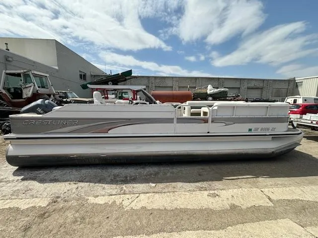 Slide: The Image of 2004 Crestliner 2485 LSI pontoon boat in a storage yard. - 1