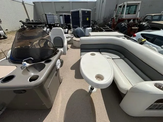 Slide: The Image of 2004 Crestliner 2485 LSI pontoon boat interior with seating and helm station. - 10