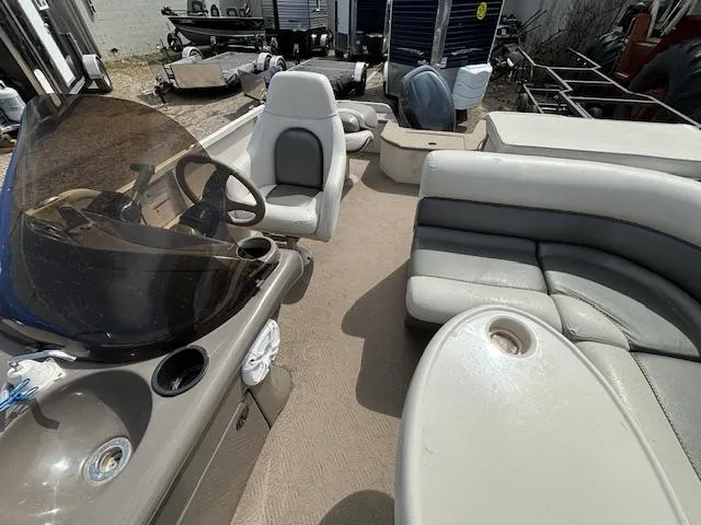 Slide: The Image of 2004 Crestliner 2485 LSI boat interior with seating and steering console. - 12
