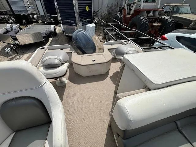 Slide: The Image of 2004 Crestliner 2485 LSI pontoon boat interior with seating and storage compartments. - 13