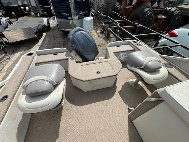 Slide: The Image of 2004 Crestliner 2485 LSI pontoon boat interior with seating and outboard motor. - 14