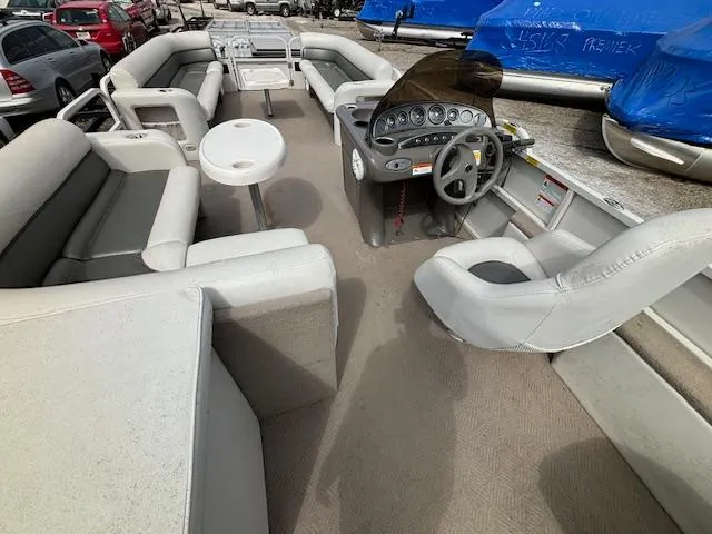Slide: The Image of 2004 Crestliner 2485 LSI pontoon boat interior with helm, seating, and table. - 20