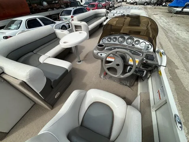 Slide: The Image of 2004 Crestliner 2485 LSI pontoon boat interior with steering console and seating. - 21