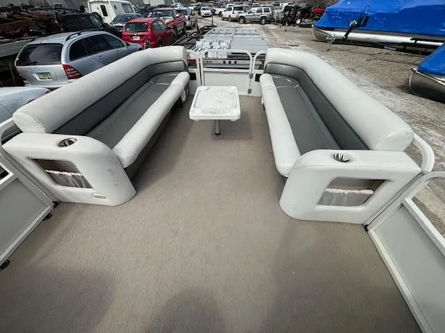 Slide: The Image of 2004 Crestliner 2485 LSI pontoon boat interior with spacious seating and table. - 26