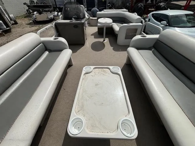 Slide: The Image of 2004 Crestliner 2485 LSI pontoon boat interior with seating and table. - 8