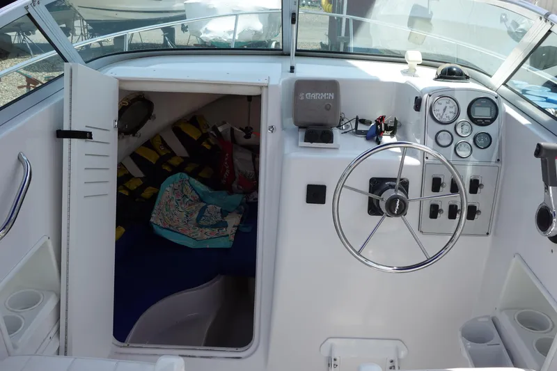 Slide: The Image of 1999 Pro-Line 221 Walk boat interior with steering wheel, gauges, and cabin entrance. - 10