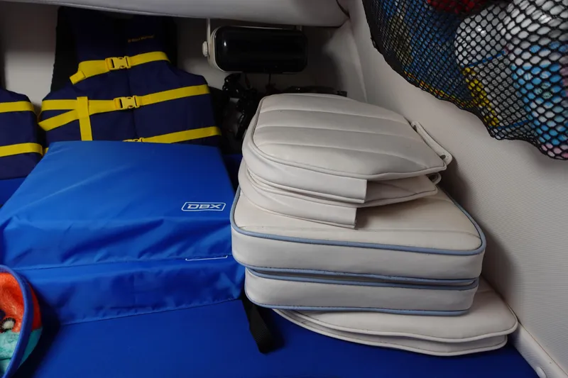 Slide: The Image of Cushions and life jackets in a 1999 Pro-Line 221 Walk boat interior. - 16
