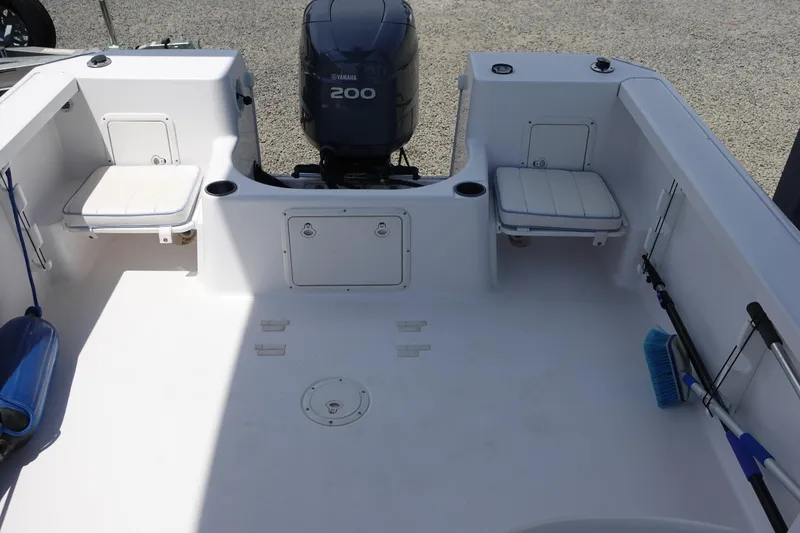 Slide: The Image of 1999 Pro-Line 221 Walk boat deck with Yamaha 200 engine, featuring seating and storage compartments. - 3