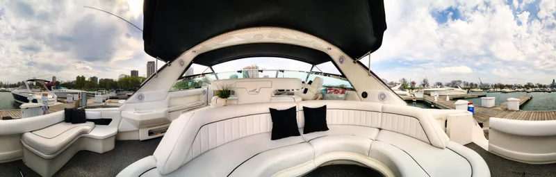 Slide: The Image of 1994 Sea Ray 500 Sundancer yacht interior with white seating and black cushions. - 10