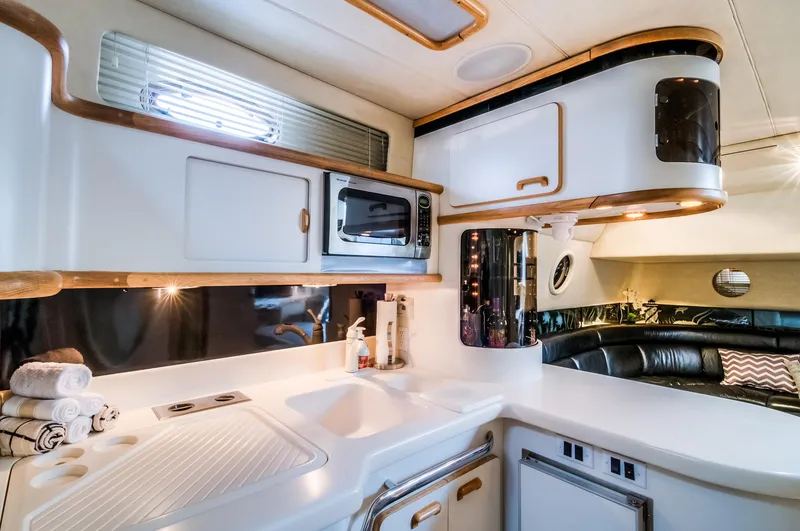 Slide: The Image of Interior kitchen of 1994 Sea Ray 500 Sundancer yacht with modern amenities. - 12