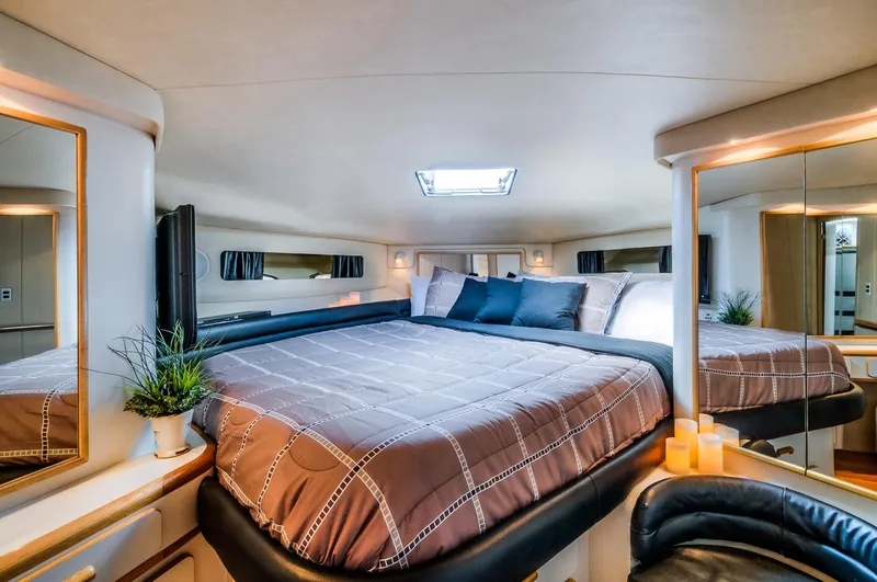 Slide: The Image of Luxurious bedroom interior of 1994 Sea Ray 500 Sundancer yacht with skylight and modern decor. - 15