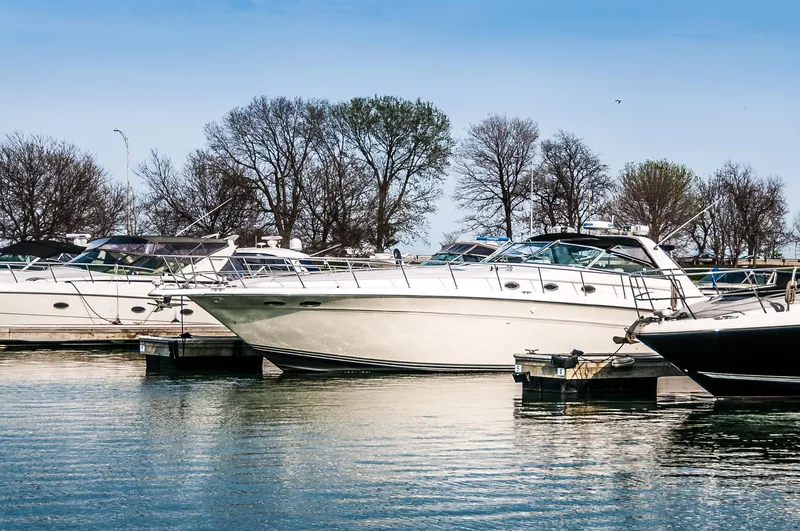 Slide: The Image of 1994 Sea Ray 500 Sundancer yacht docked in a marina with other boats. - 4